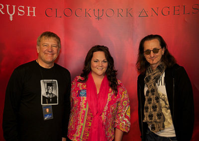 Lisa Kirkwood with Alex Lifeson and Geddy Lee of Rush